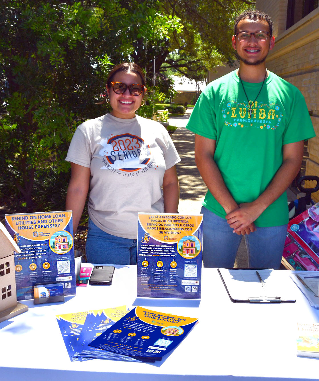 Texas Homeowner Assistance Fund outreach event with team members and bilingual flyers.